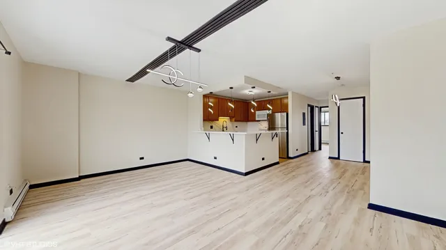 a view of a room with wooden floor