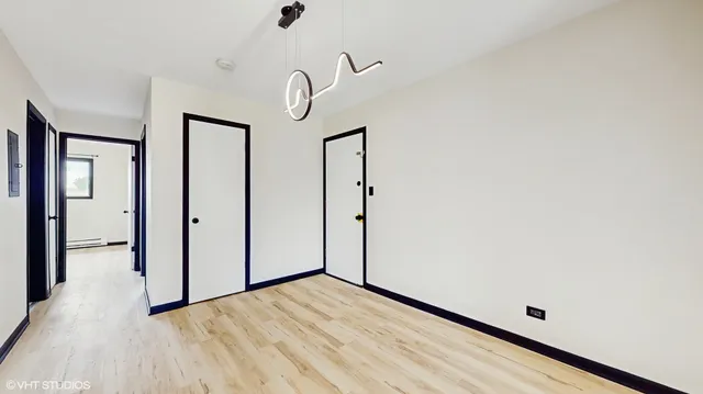a view of a room with wooden floor