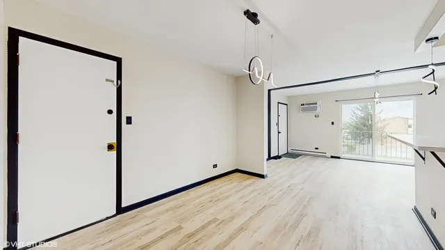 a view of a room with wooden floor and window