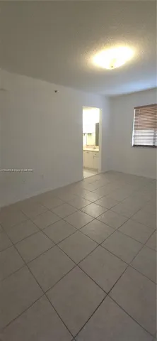 an empty room with a empty space and a window