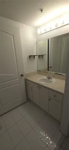 a bathroom with a granite countertop sink mirror and vanity