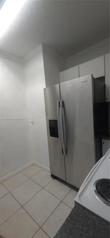 a view of a refrigerator in kitchen