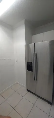 a close view of a refrigerator in kitchen and utility room