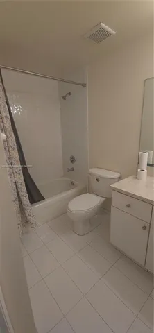 a bathroom with a granite countertop sink a toilet and bathtub