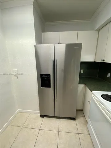 a kitchen with granite countertop a sink a counter top space appliances and cabinets