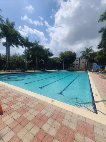 a view of a swimming pool with a lounge chair