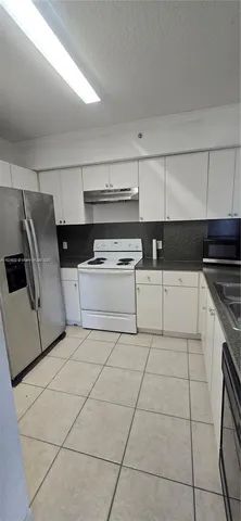a kitchen with cabinets and appliances