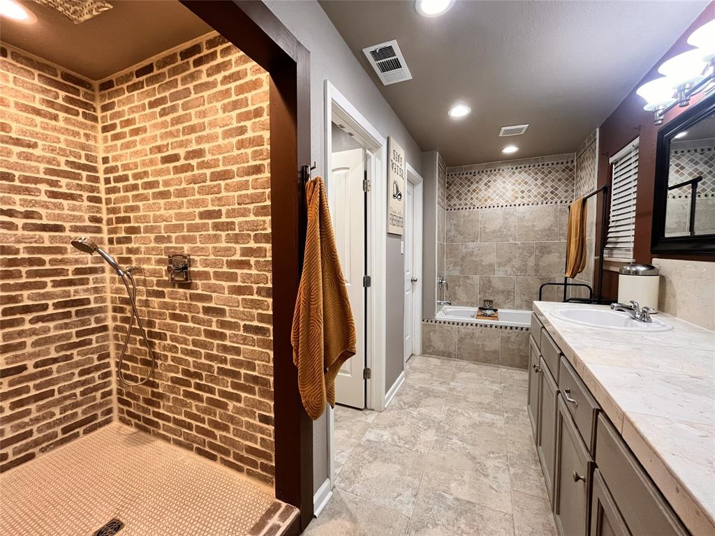 420 Sessums Road Springtown, TX 76082 - Photo 19 of 40 Master bathroom with shower, a bath, dual vanity, and recessed lighting