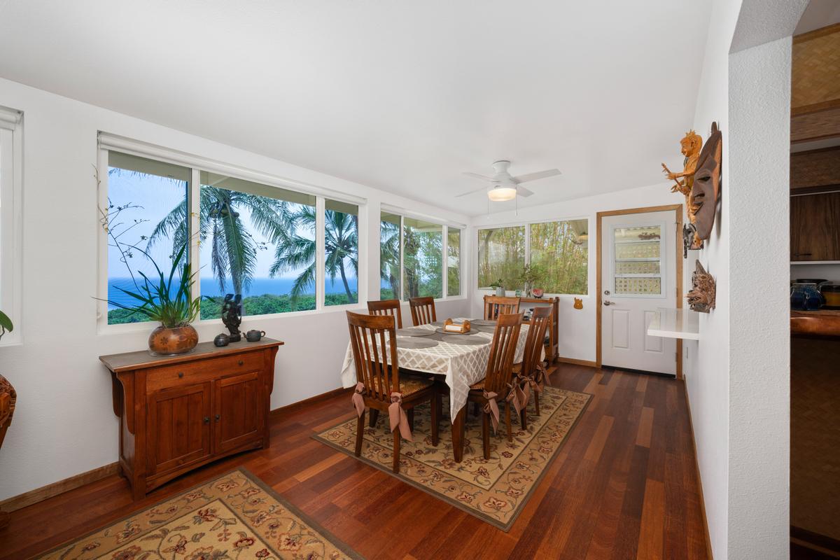 85-4563 Hawaii Belt Road Captain Cook, HI 96704 - Photo 10 of 30 a view of a dining room with furniture window and wooden floor