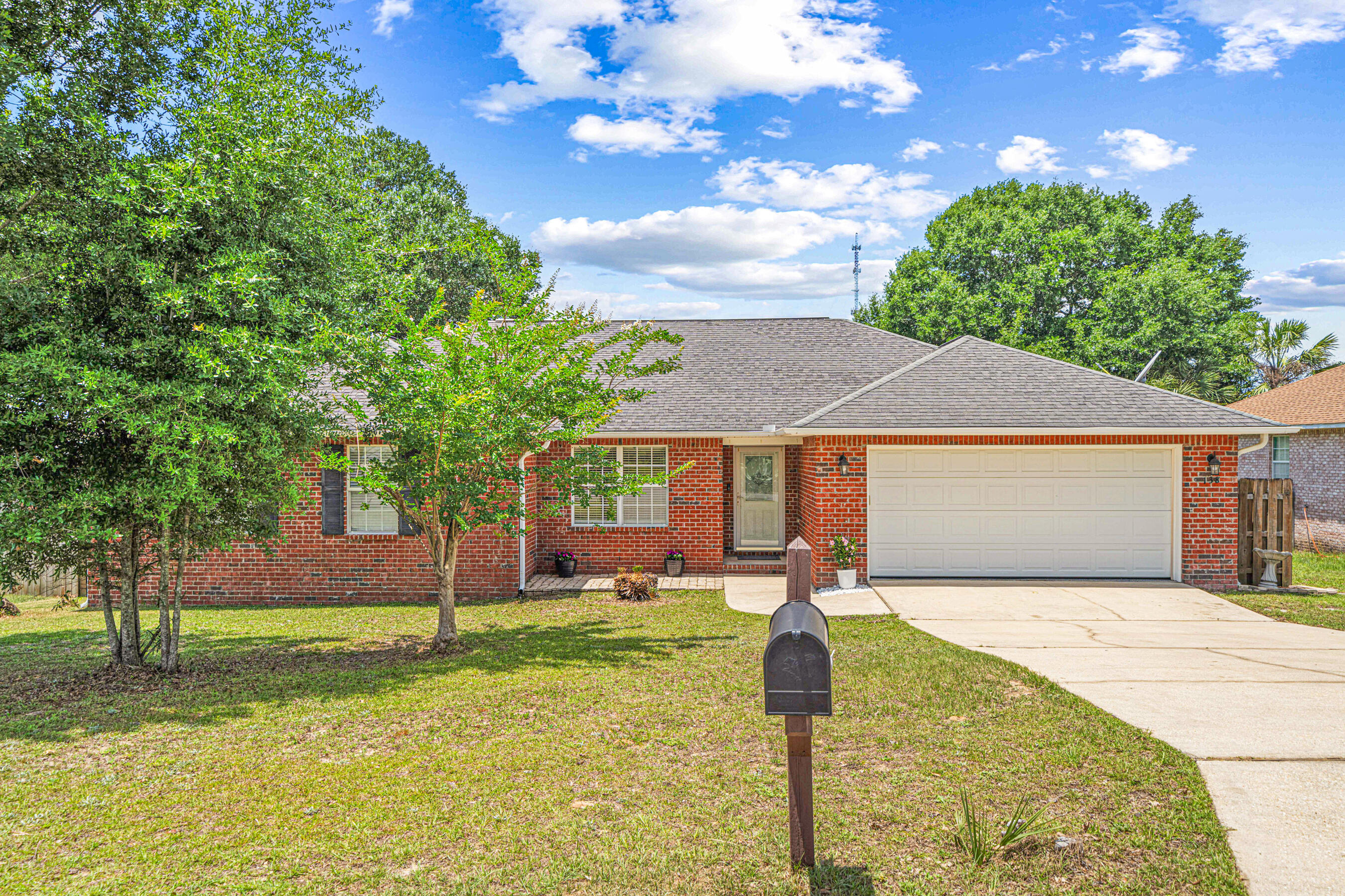 a front view of house with yard and trees