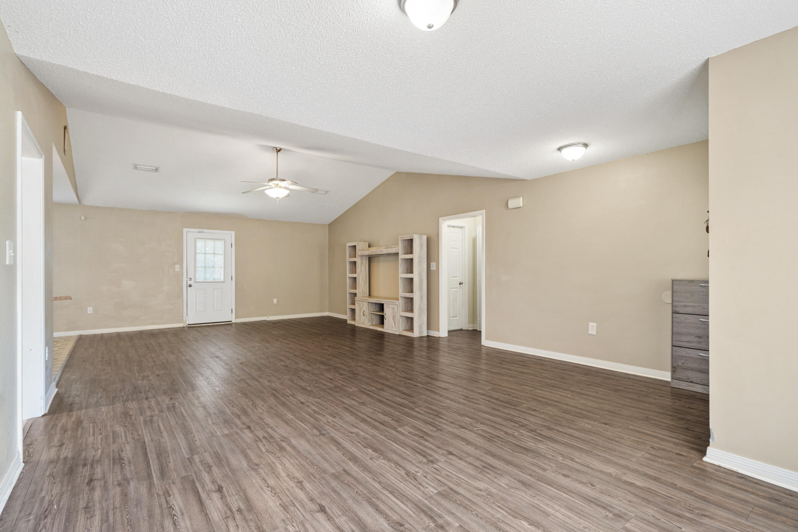 138 Conquest Avenue Crestview, FL 32536 - Photo 6 of 34 a view of an empty room with wooden floor