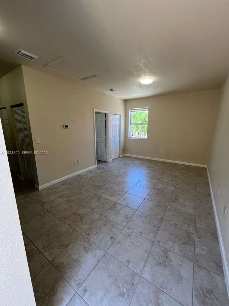 9401 Southwest 172nd Avenue, Unit STUDIO Miami, FL 33196 - Photo 2 of 12 an empty room with windows