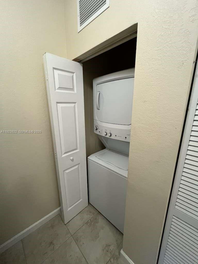 9401 Southwest 172nd Avenue, Unit STUDIO Miami, FL 33196 - Photo 5 of 12 a utility room with dryer and washer