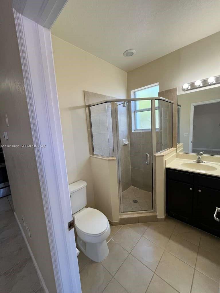 9401 Southwest 172nd Avenue, Unit STUDIO Miami, FL 33196 - Photo 6 of 12 a bathroom with a sink a toilet and shower
