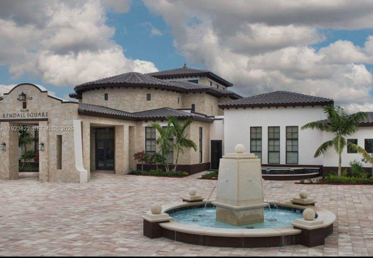 9401 Southwest 172nd Avenue, Unit STUDIO Miami, FL 33196 - Photo 8 of 12 a view of a house with a fountain in front of it