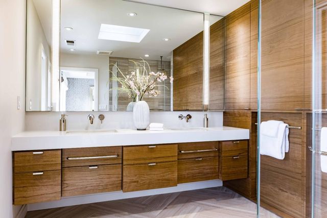 a bathroom with a granite countertop sink mirror and double