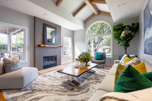 a living room with furniture fireplace and a large window