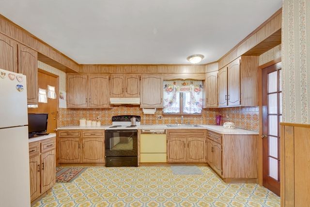 a kitchen with a sink stove and cabinets