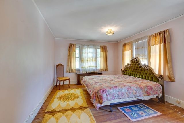 a bedroom with a bed lamp and a window