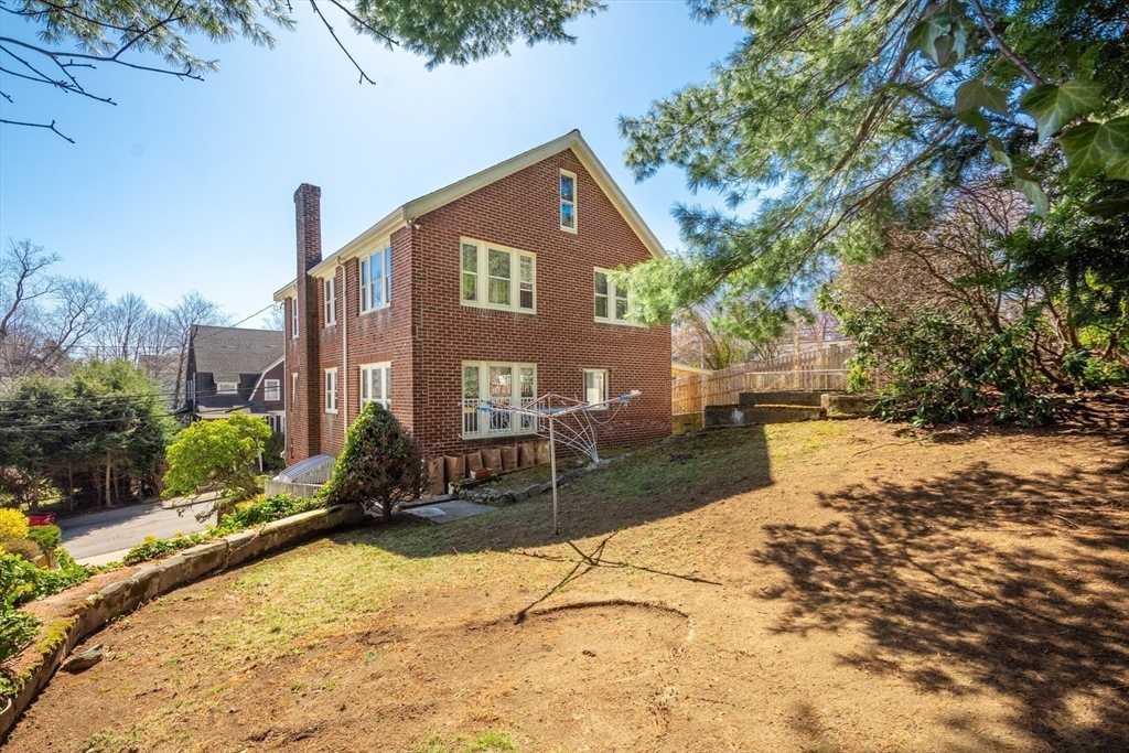 83 Bartlett Avenue Arlington, MA 02476 - Photo 18 of 22 a front view of a house with a yard