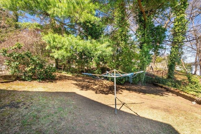 a view of a yard with wooden fence