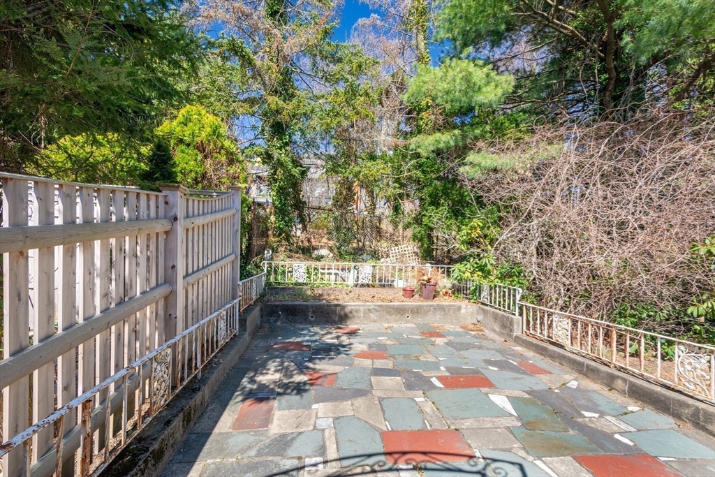 83 Bartlett Avenue Arlington, MA 02476 - Photo 20 of 22 a view of a pathway with a wrought fence