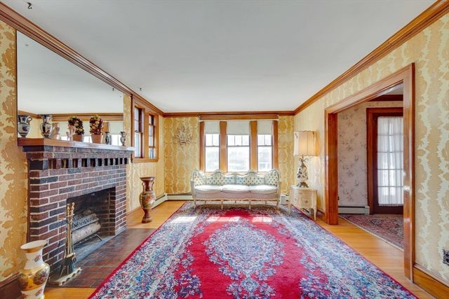 a living room with furniture a rug and a fireplace
