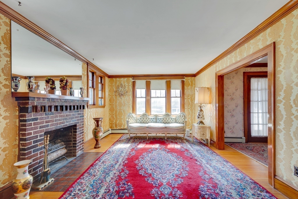 83 Bartlett Avenue Arlington, MA 02476 - Photo 7 of 22 a living room with furniture a rug and a fireplace