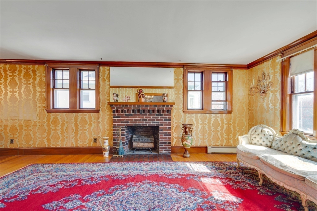 83 Bartlett Avenue Arlington, MA 02476 - Photo 8 of 22 a living room with furniture and a fireplace