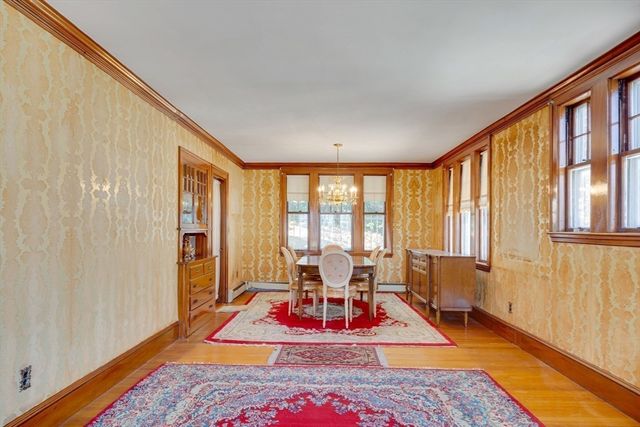 a living room with furniture a rug and a table