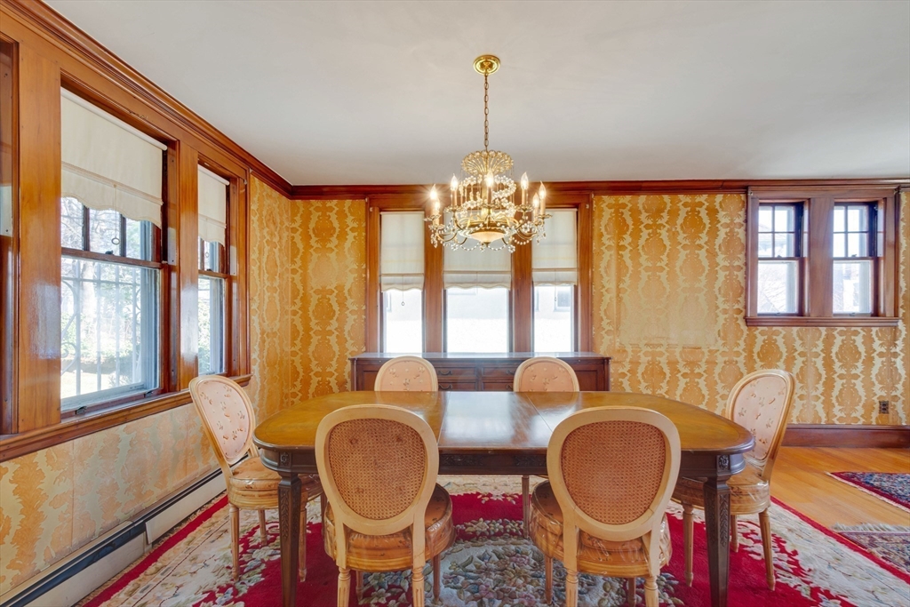 83 Bartlett Avenue Arlington, MA 02476 - Photo 10 of 22 a dining room with chandelier fan and wooden floor