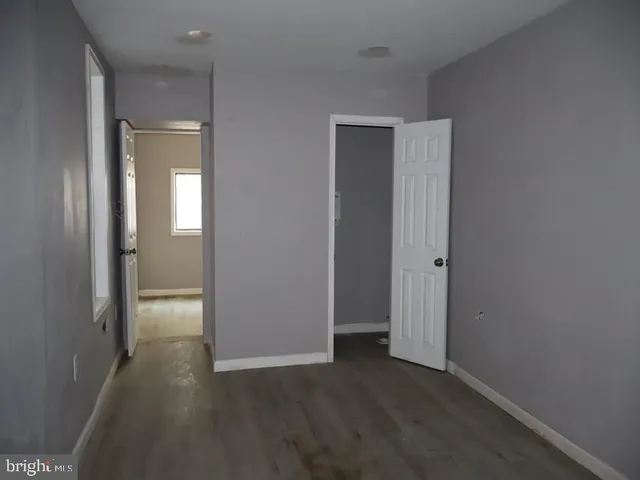a view of hallway with wooden floor