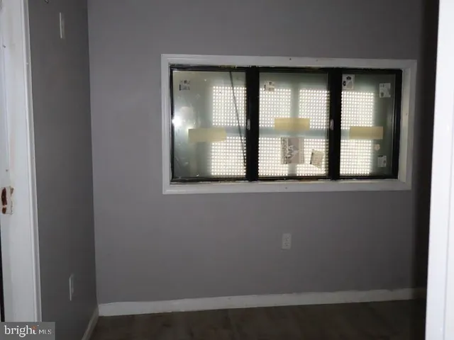 an empty room with large window and mirror