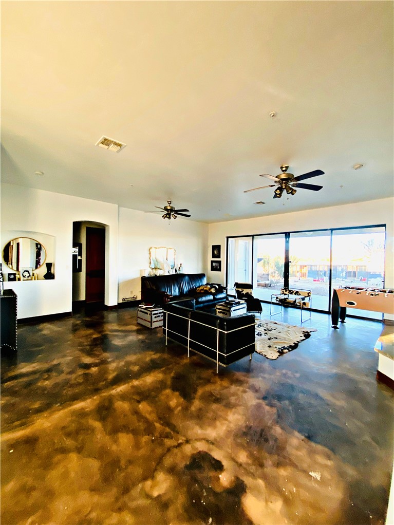 21038 South Cheyenne Road Yucca, AZ 86438 - Photo 15 of 98 Living room with ceiling fan