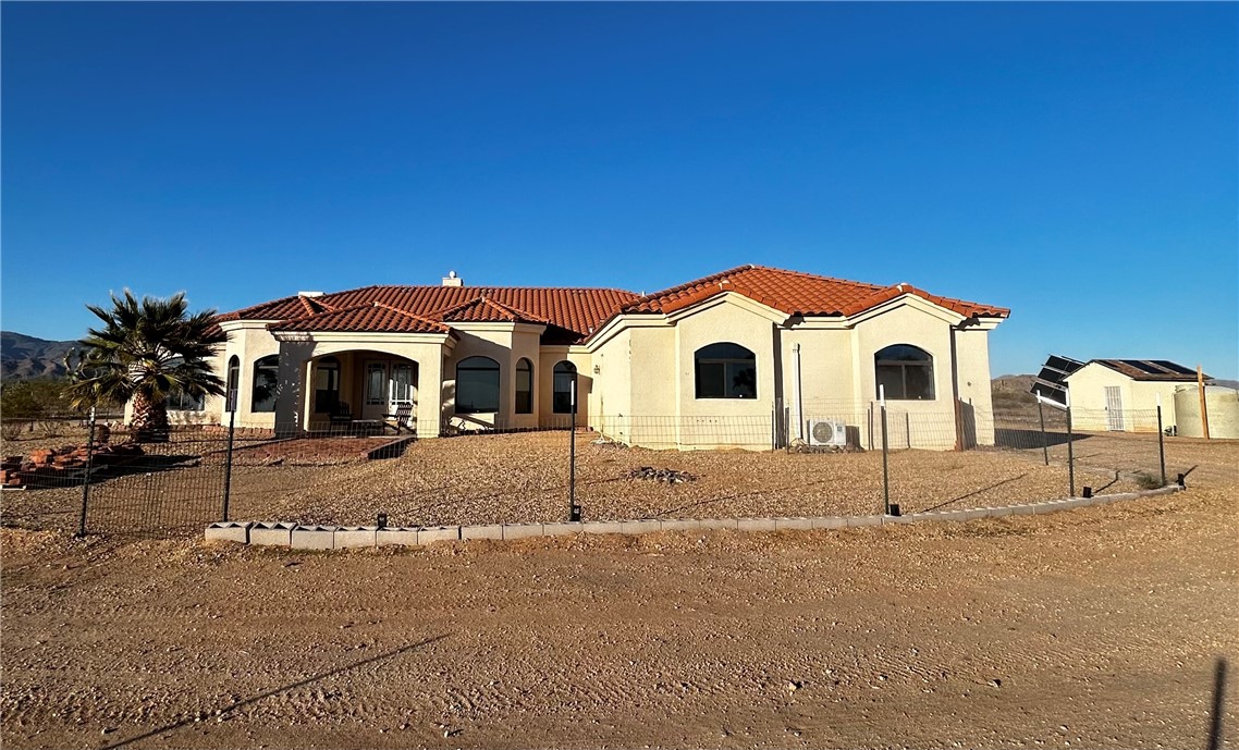 21038 South Cheyenne Road Yucca, AZ 86438 - Photo 2 of 98 Mediterranean / spanish house featuring stucco siding and a tile roof