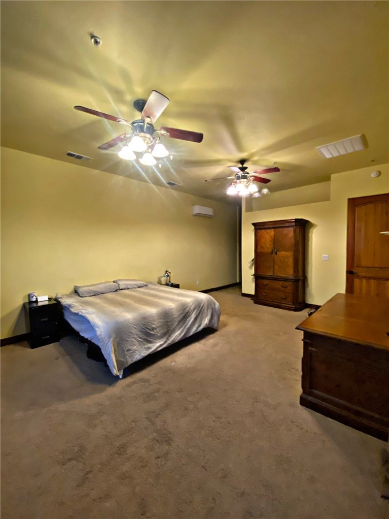 21038 South Cheyenne Road Yucca, AZ 86438 - Photo 33 of 98 Bedroom with carpet and ceiling fan