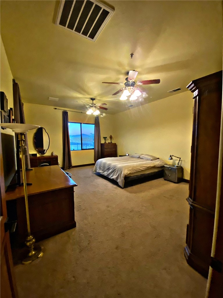 21038 South Cheyenne Road Yucca, AZ 86438 - Photo 34 of 98 Carpeted bedroom with ceiling fan