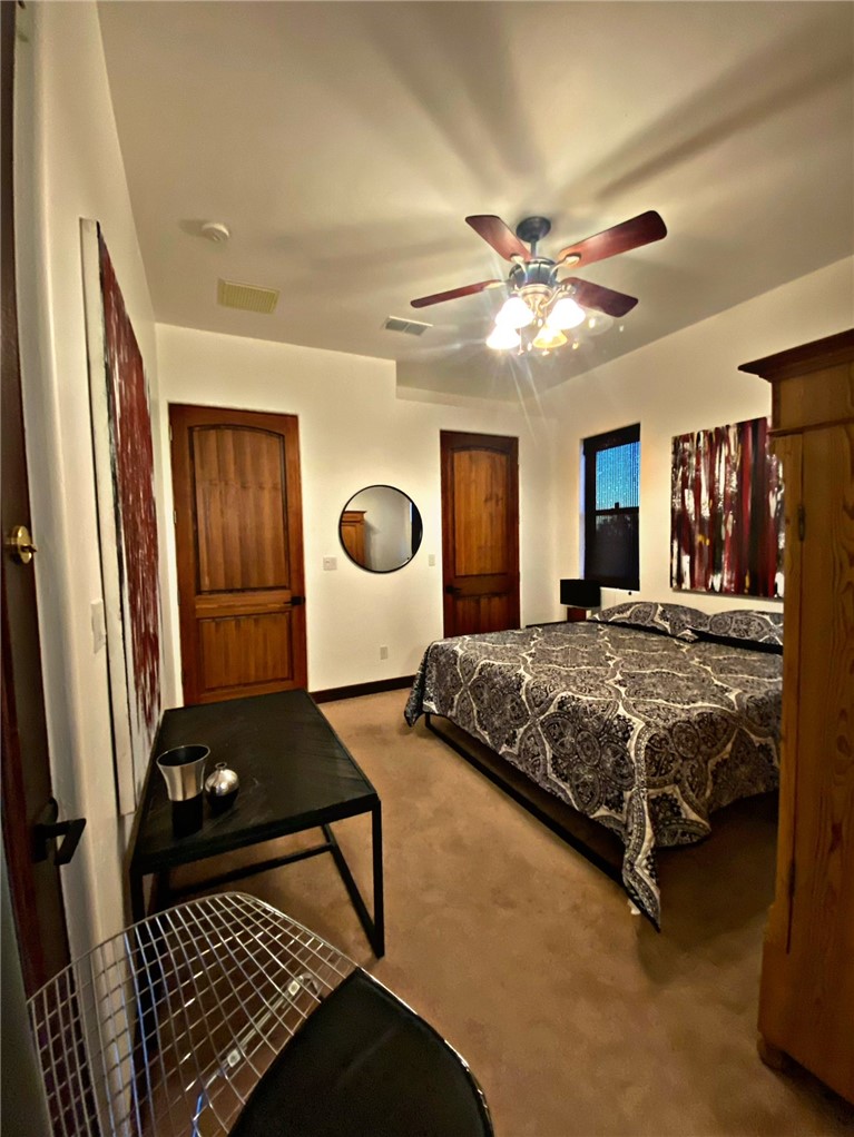 21038 South Cheyenne Road Yucca, AZ 86438 - Photo 44 of 98 Guest Bedroom 2 featuring light carpet and ceiling fan
