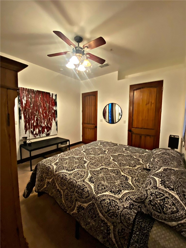 21038 South Cheyenne Road Yucca, AZ 86438 - Photo 45 of 98 Bedroom with ceiling fan and carpet flooring