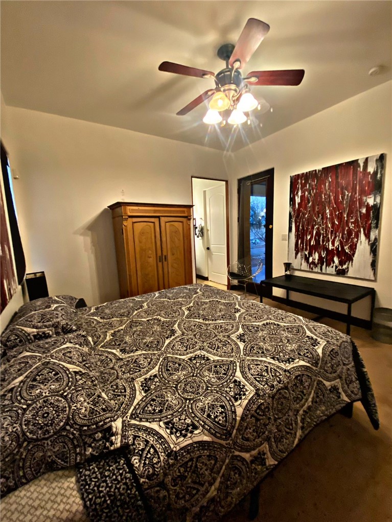 21038 South Cheyenne Road Yucca, AZ 86438 - Photo 46 of 98 Guest Bedroom with ceiling fan and carpet flooring