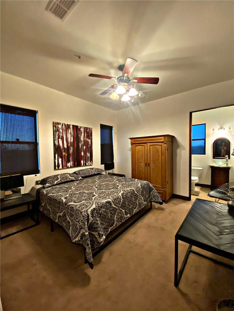 21038 South Cheyenne Road Yucca, AZ 86438 - Photo 47 of 98 Bedroom with light carpet and ceiling fan