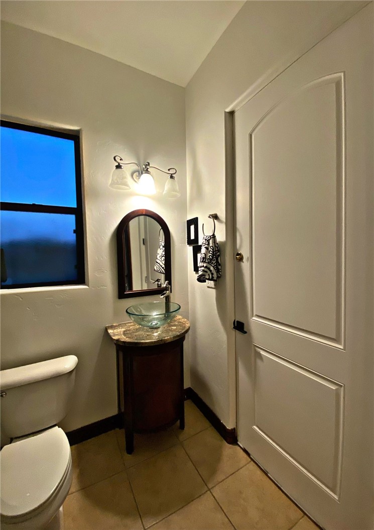 21038 South Cheyenne Road Yucca, AZ 86438 - Photo 49 of 98 Bathroom featuring vanity, mirror, and light tile floors