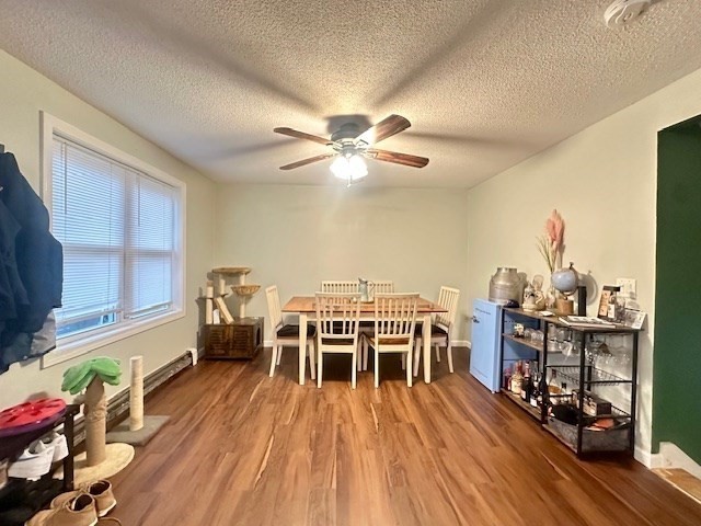 113 Harvard Street, Unit 1 Everett, MA 02149 - Photo 15 of 24 a dining room with furniture a chandelier and wooden floor