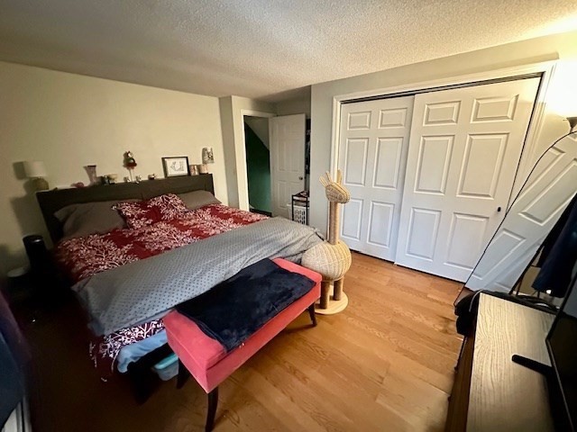 113 Harvard Street, Unit 1 Everett, MA 02149 - Photo 17 of 24 a bedroom with a bed with wooden floor