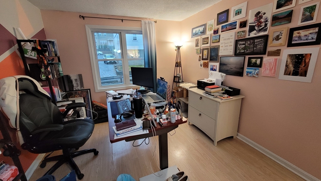 113 Harvard Street, Unit 1 Everett, MA 02149 - Photo 20 of 24 a view of a workspace with furniture and a window