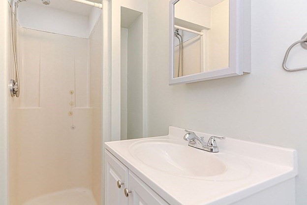 113 Harvard Street, Unit 1 Everett, MA 02149 - Photo 24 of 24 a bathroom with a sink and a mirror
