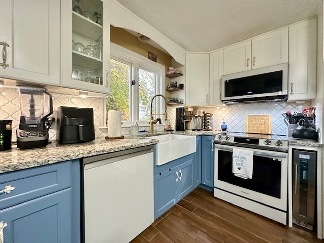 113 Harvard Street, Unit 1 Everett, MA 02149 - Photo 5 of 24 a kitchen with stainless steel appliances granite countertop a sink a stove and a microwave