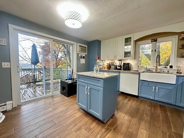 113 Harvard Street, Unit 1 Everett, MA 02149 - Photo 6 of 24 a kitchen with a sink cabinets and wooden floor