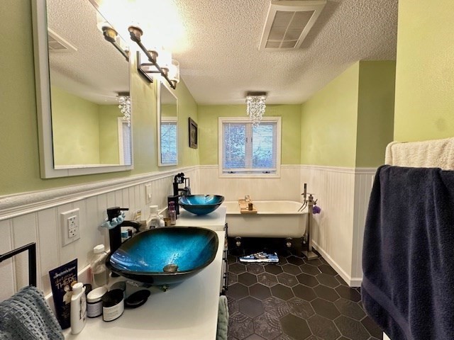 113 Harvard Street, Unit 1 Everett, MA 02149 - Photo 9 of 24 a bathroom with a sink a toilet and a mirror