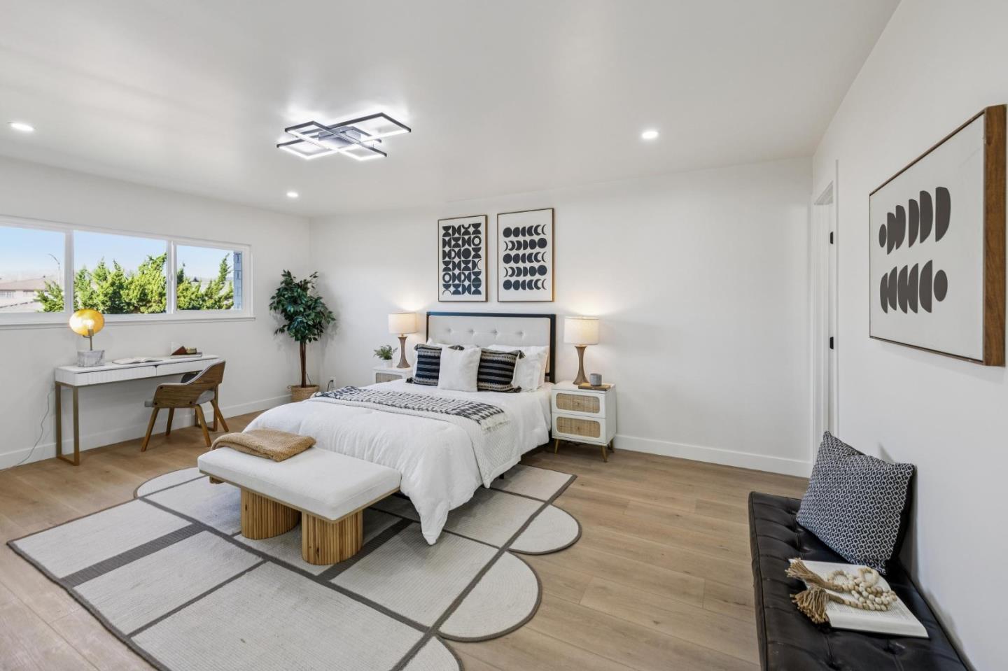 2043 Shellback Place San Jose, CA 95133 - Photo 23 of 52 a spacious bedroom with a bed and a table in it